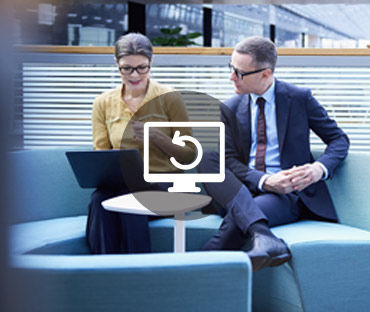 Businessman and woman looking at laptop